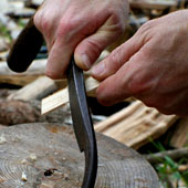 Shaving wood with a drawknife